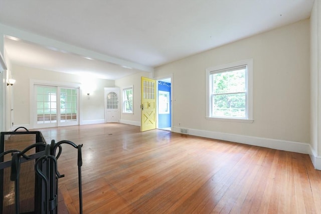 44 Huntington Ave, Sharon, MA 02067 - unfurnished living room featuring plenty of natural light, baseboards, and hardwood / wood-style flooring