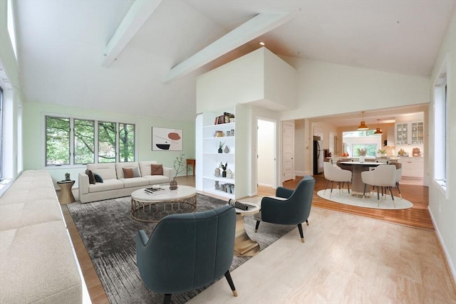 44 Huntington Ave, Sharon, MA 02067 - living area featuring high vaulted ceiling, light wood-type flooring, beamed ceiling, and baseboards