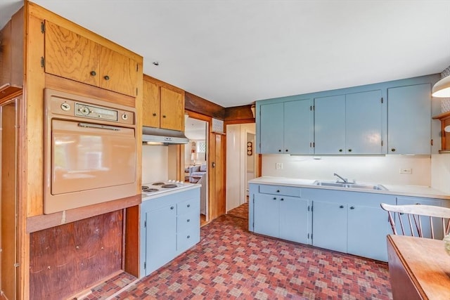 575 Nauset Rd, Eastham, MA 02642 - kitchen with white appliances, a sink, blue cabinets, light countertops, and light flooring