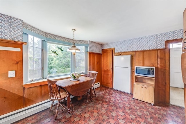 575 Nauset Rd, Eastham, MA 02642 - dining room featuring wallpapered walls, a baseboard heating unit, and wooden walls