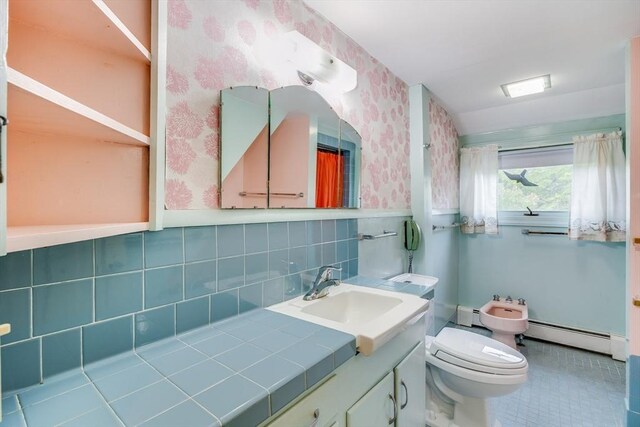 575 Nauset Rd, Eastham, MA 02642 - bathroom featuring wallpapered walls, a baseboard heating unit, vanity, toilet, and a bidet