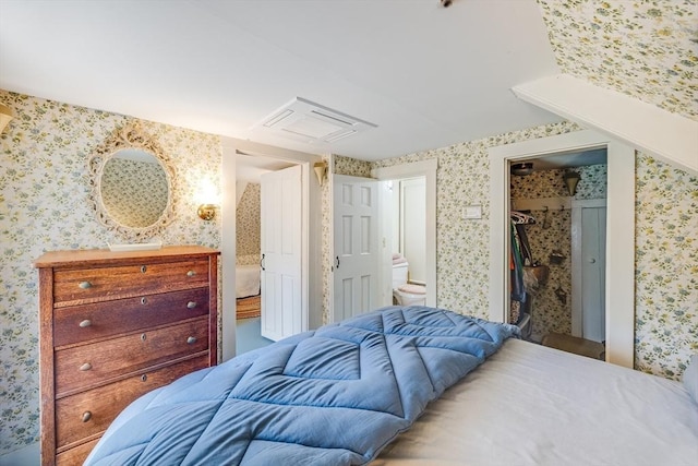 575 Nauset Rd, Eastham, MA 02642 - bedroom featuring wallpapered walls, a spacious closet, ensuite bathroom, and a closet