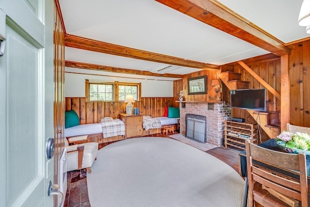 575 Nauset Rd, Eastham, MA 02642 - living room featuring wooden walls, beam ceiling, a brick fireplace, and a wainscoted wall