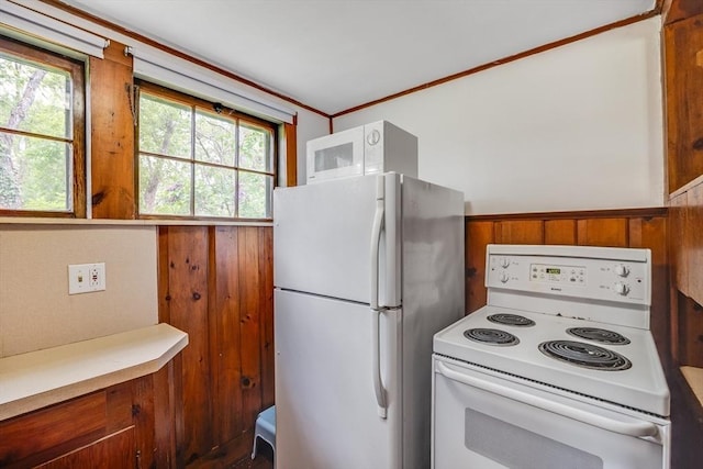 575 Nauset Rd, Eastham, MA 02642 - kitchen with white appliances, wainscoting, brown cabinets, ornamental molding, and light countertops