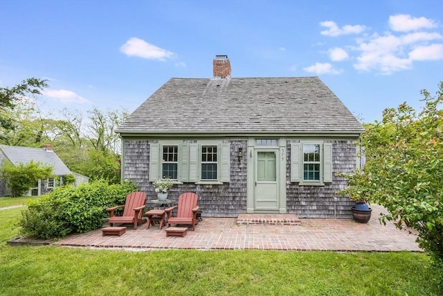 575 Nauset Rd, Eastham, MA 02642 - rear view of property with a chimney, a yard, and a patio