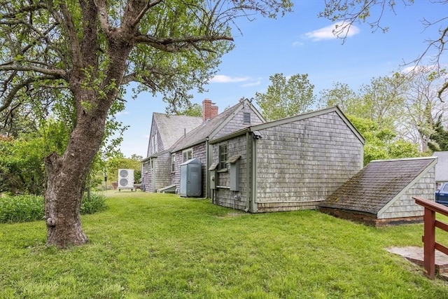 575 Nauset Rd, Eastham, MA 02642 - view of side of home with a chimney and a lawn