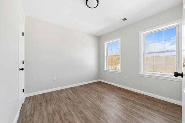 spare room with wood-type flooring