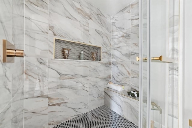 bathroom with a tile shower