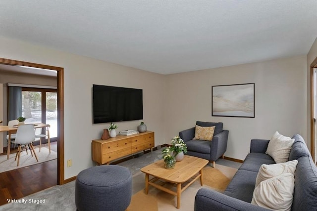 living area with carpet and baseboards