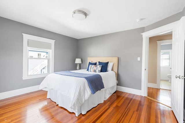 bedroom with baseboards and wood-type flooring