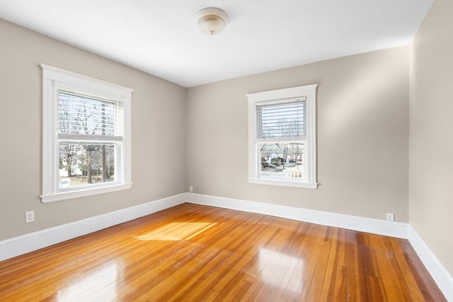 empty room featuring hardwood / wood-style floors and baseboards