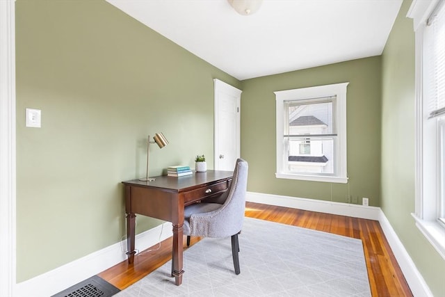 office space featuring visible vents, wood finished floors, and baseboards