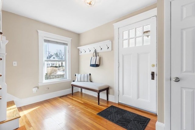 entrance foyer with light wood-style flooring and baseboards