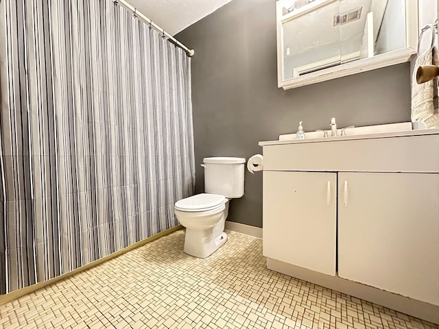 bathroom featuring tile patterned flooring, vanity, curtained shower, and toilet