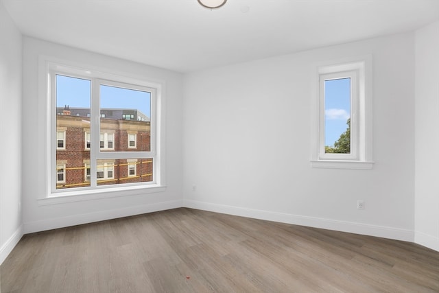 unfurnished room with light hardwood / wood-style floors