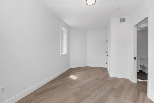 empty room with light hardwood / wood-style flooring