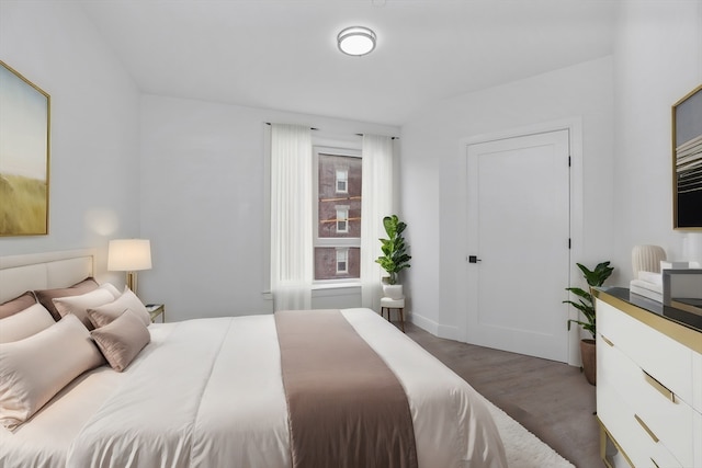 bedroom with dark wood-type flooring