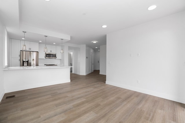 unfurnished living room featuring light wood-type flooring