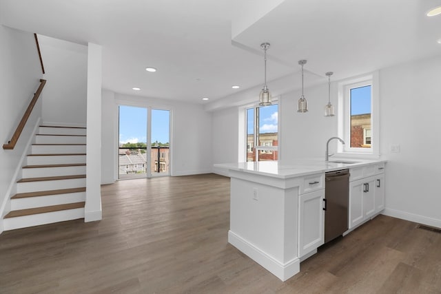 kitchen with dishwasher, dark hardwood / wood-style flooring, sink, and white cabinets