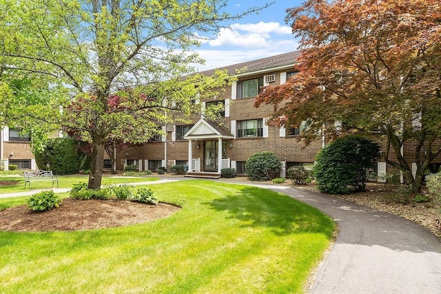 45 Macy St Unit B-205, Amesbury, MA 01913 - view of front of home featuring a front lawn and brick siding