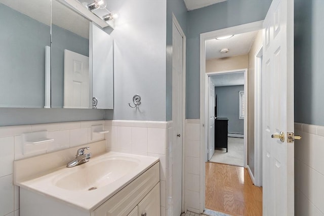 45 Macy St Unit B-205, Amesbury, MA 01913 - bathroom with a baseboard radiator, wood finished floors, vanity, and a wainscoted wall