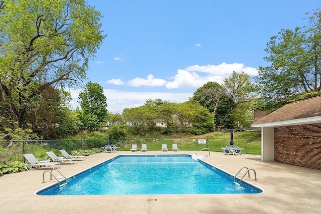 45 Macy St Unit B-205, Amesbury, MA 01913 - community pool featuring a patio, fence, and view of scattered trees