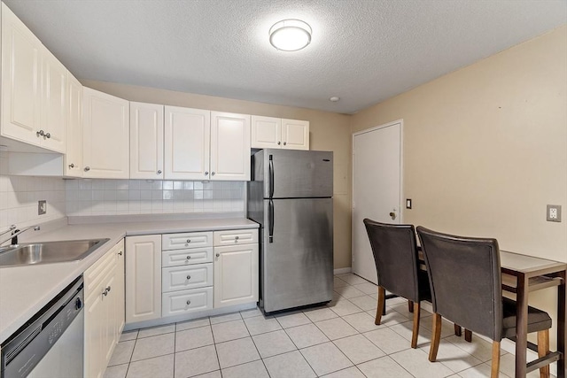 45 Macy St Unit B-205, Amesbury, MA 01913 - kitchen with appliances with stainless steel finishes, a sink, a textured ceiling, white cabinets, and light countertops