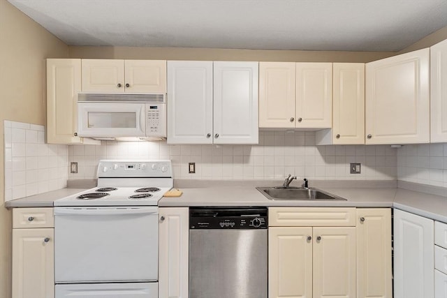 45 Macy St Unit B-205, Amesbury, MA 01913 - kitchen with white appliances, a sink, tasteful backsplash, and white cabinetry