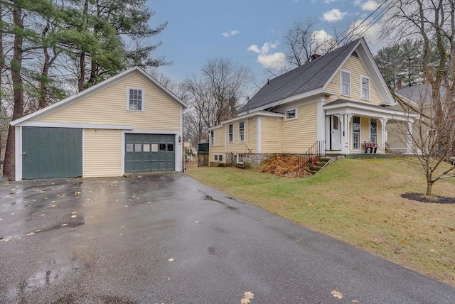 view of property exterior featuring covered porch, a yard, and a garage