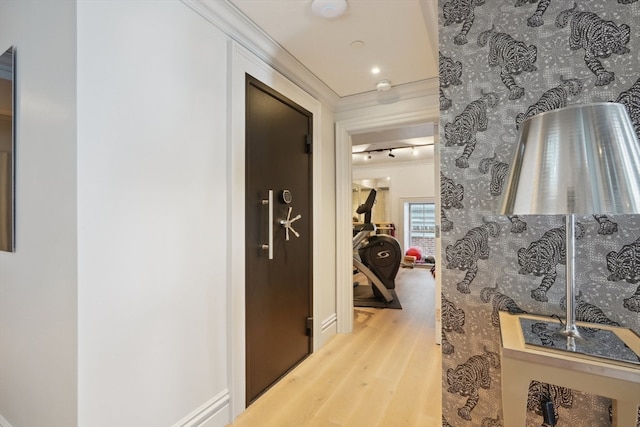 hall featuring crown molding and light hardwood / wood-style floors