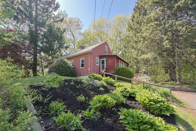 view of property exterior with a chimney