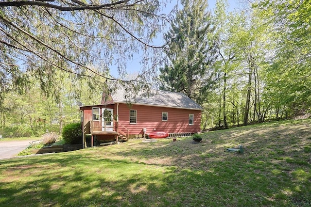 view of property exterior featuring a lawn
