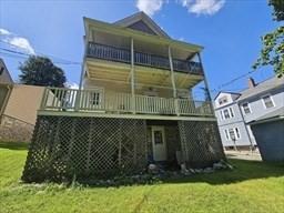 7 Kensington Rd, Worcester, MA 01602 - back of property with a balcony and a yard