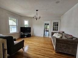 7 Kensington Rd, Worcester, MA 01602 - living room with wood finished floors and a chandelier