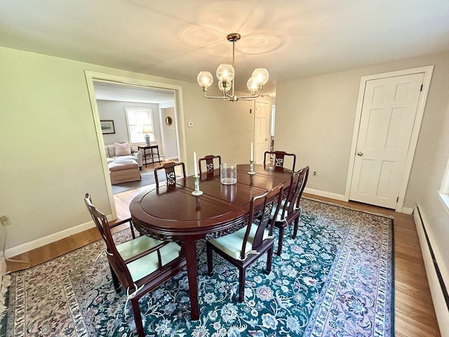 53 Washington St, Topsfield, MA 01983 - dining room featuring a baseboard heating unit, wood finished floors, and a chandelier