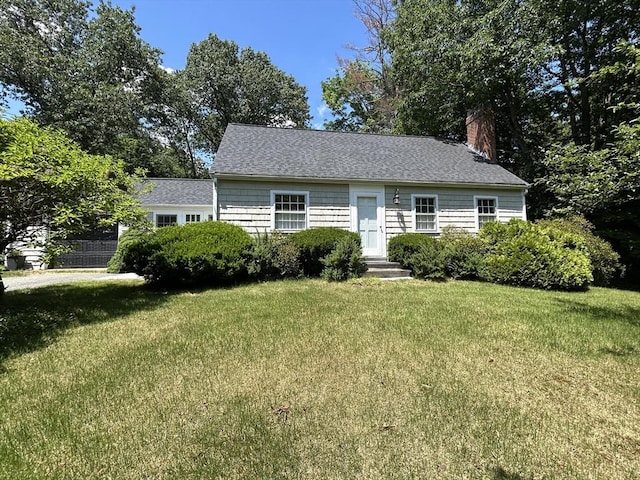 53 Washington St, Topsfield, MA 01983 - view of front of house featuring a chimney, a front lawn, and roof with shingles