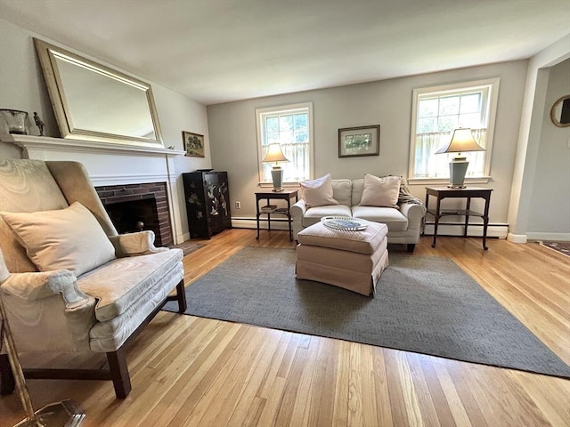 53 Washington St, Topsfield, MA 01983 - living area with a baseboard radiator, healthy amount of natural light, and a fireplace
