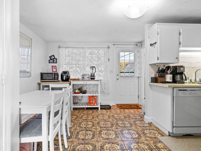 84 Lancaster Rd Unit 84, Dedham, MA 02026 - kitchen featuring tasteful backsplash, white cabinetry, dishwasher, light countertops, and stainless steel microwave