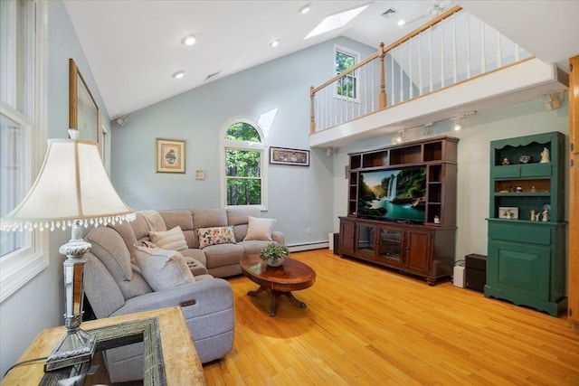 290 Mendell Rd, Rochester, MA 02770 - living room with a skylight, wood finished floors, high vaulted ceiling, baseboard heating, and recessed lighting