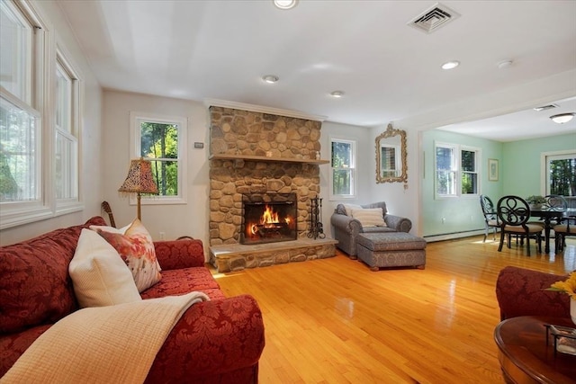 290 Mendell Rd, Rochester, MA 02770 - living area featuring wood finished floors, a baseboard radiator, a fireplace, and recessed lighting