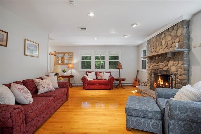 290 Mendell Rd, Rochester, MA 02770 - living area with light wood-style flooring, a fireplace, a baseboard heating unit, and a baseboard radiator