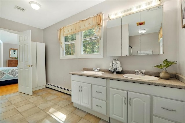 290 Mendell Rd, Rochester, MA 02770 - ensuite bathroom with a baseboard radiator, double vanity, and tile patterned floors