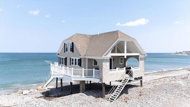 14 Stanton Ln, Scituate, MA 02066 - view of front of house with a view of the beach, roof with shingles, and a deck with water view