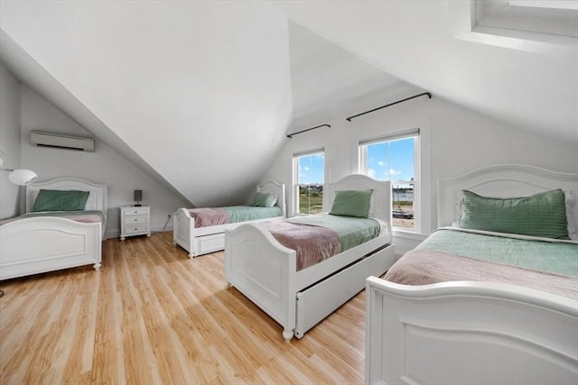 14 Stanton Ln, Scituate, MA 02066 - bedroom featuring a wall unit AC, lofted ceiling, and light wood-style flooring
