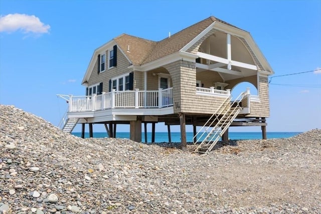 14 Stanton Ln, Scituate, MA 02066 - view of front of house with stairway, a water view, a porch, and roof with shingles