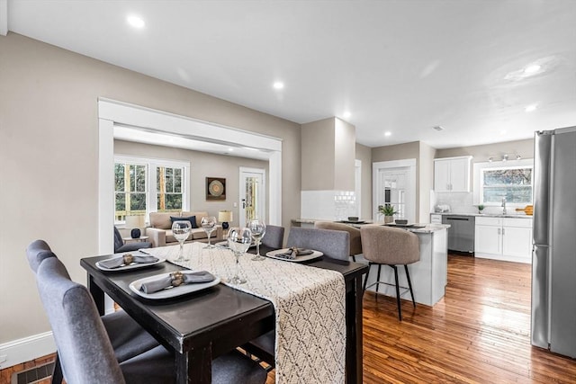 dining space featuring recessed lighting, visible vents, baseboards, and wood finished floors