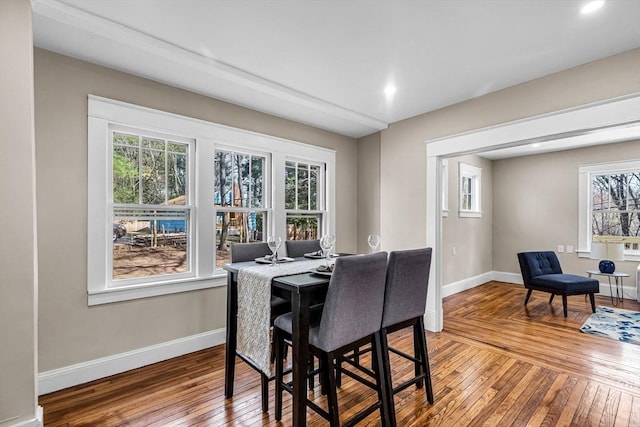 dining room featuring wood-type flooring, baseboards, and recessed lighting