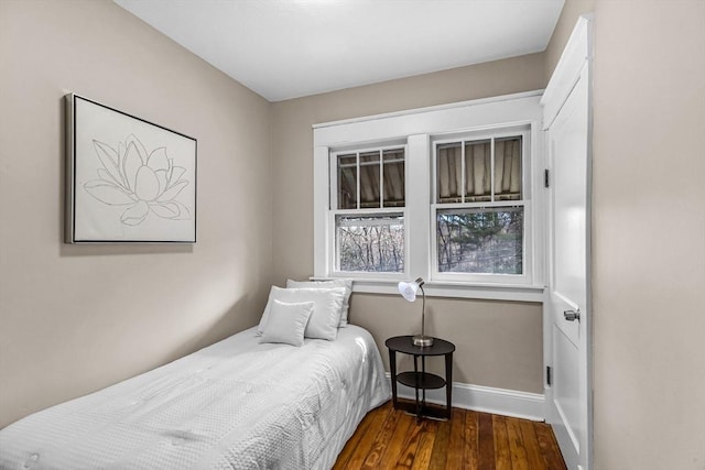 bedroom with baseboards and wood finished floors