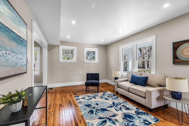 living room featuring baseboards, recessed lighting, and parquet flooring