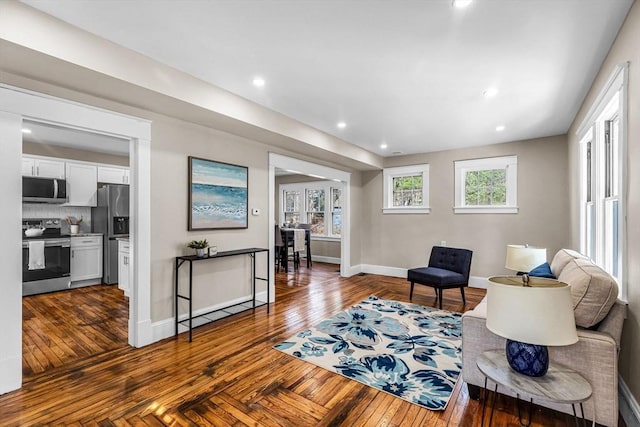 sitting room with hardwood / wood-style floors, baseboards, and recessed lighting